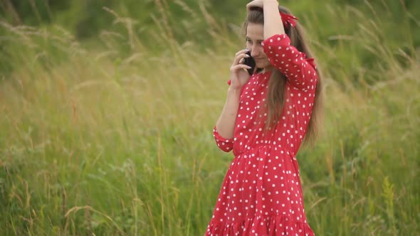 Girl in Red Dress Talking on the Phone