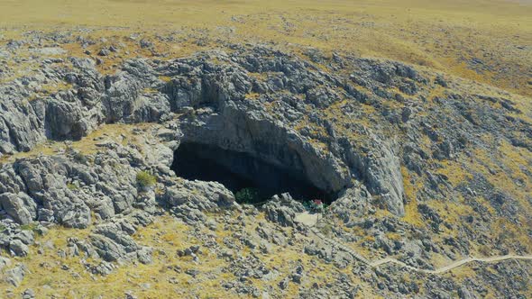 Around Sinkhole AkMechet Cave with Trees Inside in Kazakhstan Mountain