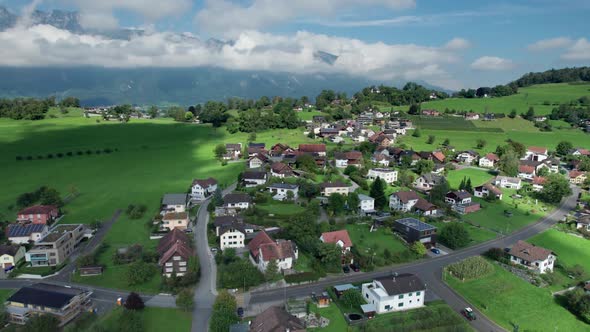 Aerial View of Liechtenstein with Houses on Green Fields in Alps Mountain Valley