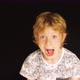 Young boy screams in front of black background - VideoHive Item for Sale