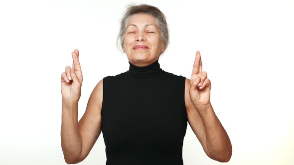 Adult Caucasian Grandmother Standing with Closed Eyes Thinking About Something Pleasant Making Wish