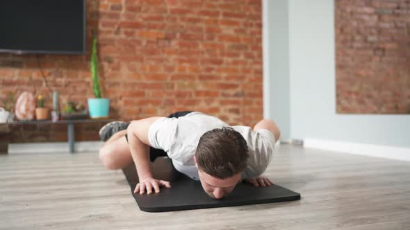 Sporty Young Guy Conducts an Online Sport Exercises at Home, Smartphone Camera