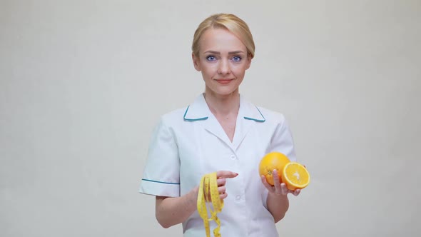 Nutritionist Doctor Healthy Lifestyle Concept - Holding Orange Fruit