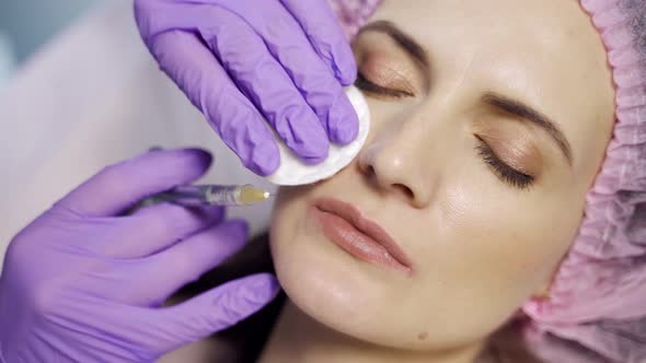 An Aesthetic Medicine Doctor Makes Botox to the Client's Lips