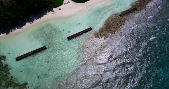 Beautiful drone copy space shot of a white sandy paradise beach and aqua blue water background 