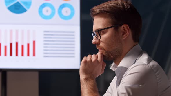 Thinking young businessman at work in office