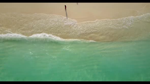 Aerial top view panorama of idyllic island beach trip by clear sea and white sandy background of jou