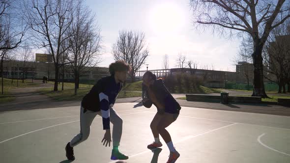 Slow motion shot of man and woman playing basketball