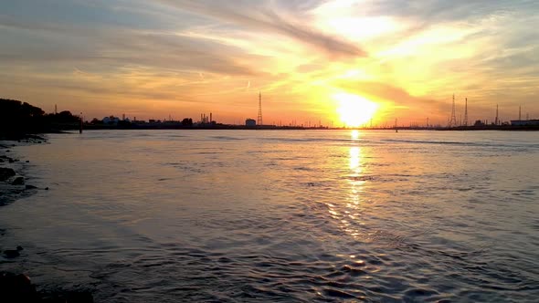 Low angle drone shot of the river estuary antwerp international port