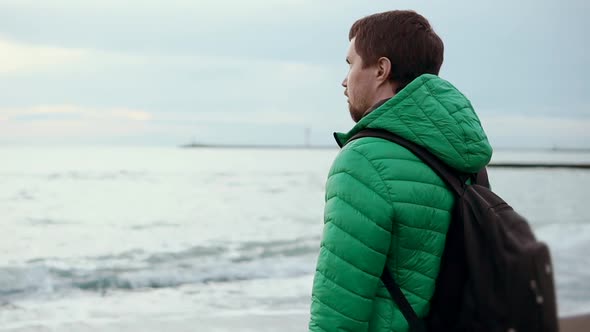 Tourist Man Is Watching Sea Horizon in Cloudy Fall Day, Side View