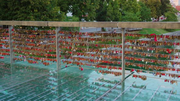 Glass Bridge with Locks on Railing Over Ljubljana River