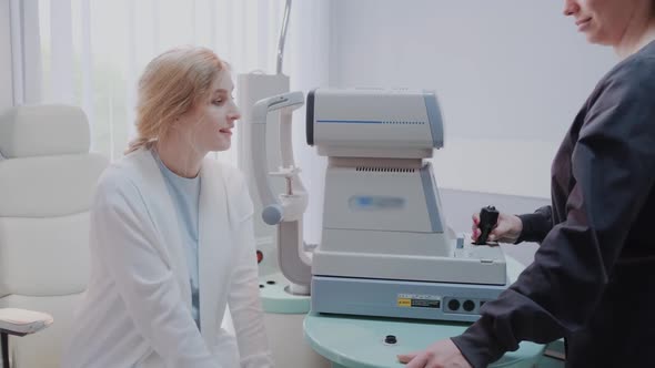 Doctor Testing for Eyes with Special Optical Apparatus in Modern Clinic