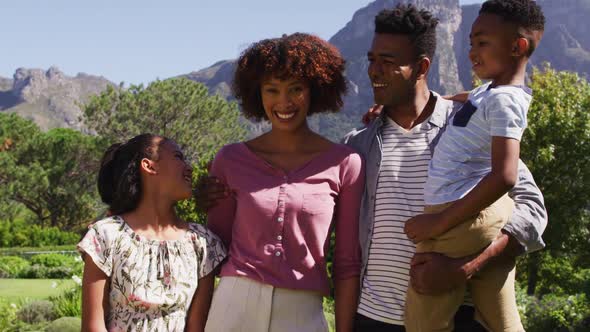 Portrait of happy african american parents, daughter and son standing outdoors