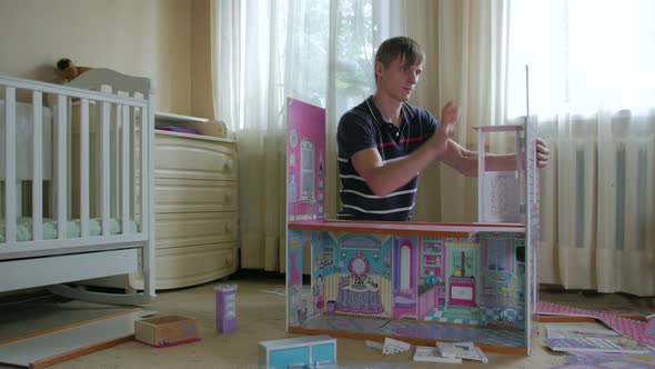 Young Man Construct Toy House