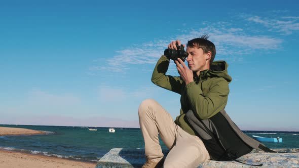 Photographer Sits on Boat Shoots Landscape