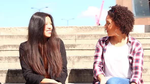 Multiracial female friends meeting in London, talking and having fun together