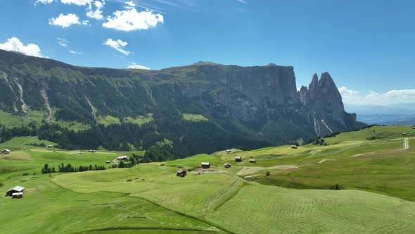 Wooden cottages under the mountains on a sunny summer day