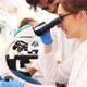 Young Scientist Looking Through Microscope in Laboratory - VideoHive Item for Sale