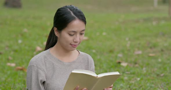 Young woman read a book at park