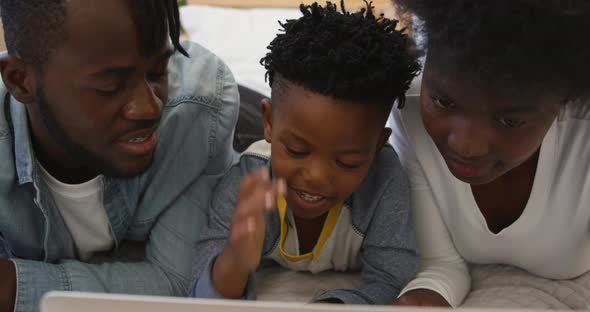 Family using laptop together at home