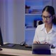 Asian businesswoman or freelancer is busy at work, she talks on the phone and types until overtime - VideoHive Item for Sale