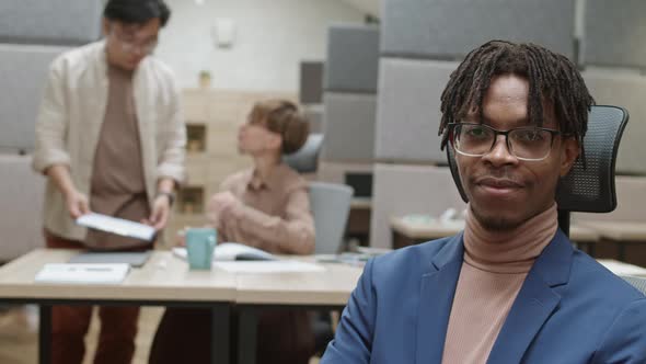 Portrait of Young Smiling African Businessman in Office