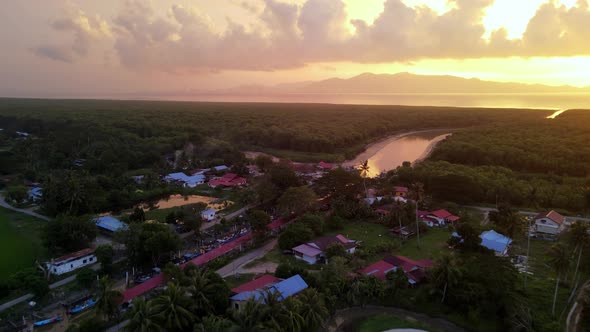 Drone shot fishing village beside mangrove forest