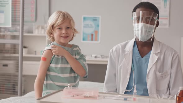 Portrait of Little Boy with Doctor after Vaccination