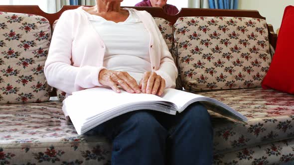 Senior woman reading book in braille