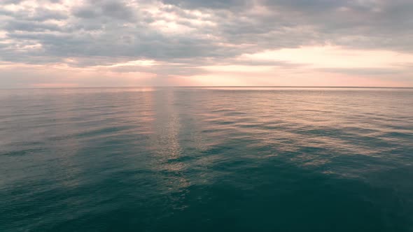 Aerial video over the morning calm sea and beautiful sunrise