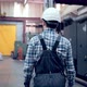 Engineer in Hard Hat is Walking Through Factory - VideoHive Item for Sale