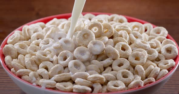 Stream of milk slowly poured into a bowl of cereal - morning breakfast. Blackmagic Ursa Pro G2, 300 