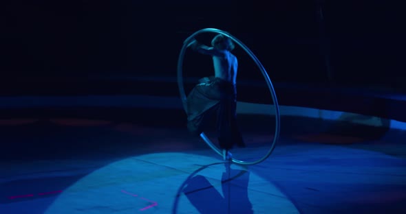 Wheel Gymnastics Tricks Performed By a Young Man on Stage of a Circus