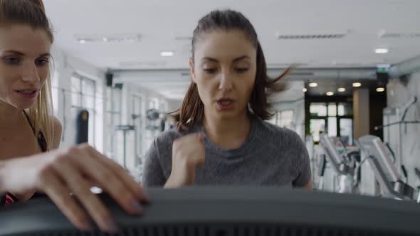 Female fitness instructor training young woman.  Shot with RED helium camera in 8K