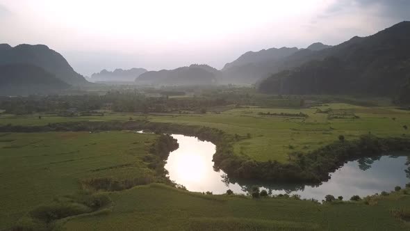 Winding River Reflects Green Trees Against Forestry Hills