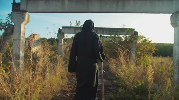 Portrait of Scary Grim Reaper with Scythe at Sunset