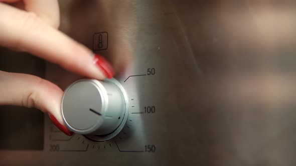 Woman Adjusting Temperature On Oven. Household Equipment On Kitchen. Home Kitchen Appliances.