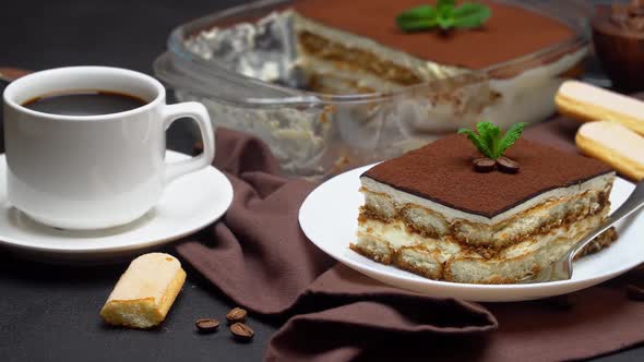 Portion of Traditional Italian Tiramisu Dessert Cup of Espresso and Baking Dish