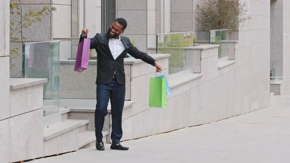 Millennial Young Adult Black Male Student Personal Assistant Walking Out of Mall Boutique Store with