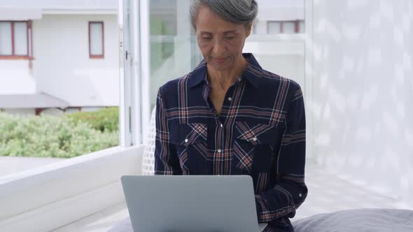 Mature woman using laptop at home