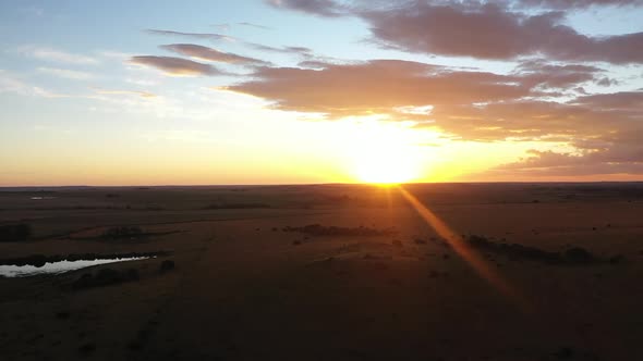 Panning cinematic aerial shot of an African sunset