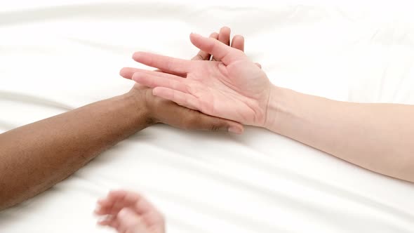Hands Close Up Multiracial Family Love African Man Caucasian Woman and Child Touch Each Other on