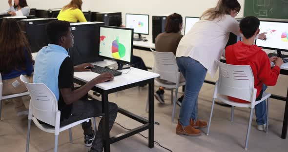 Young multiracial students using computer at school