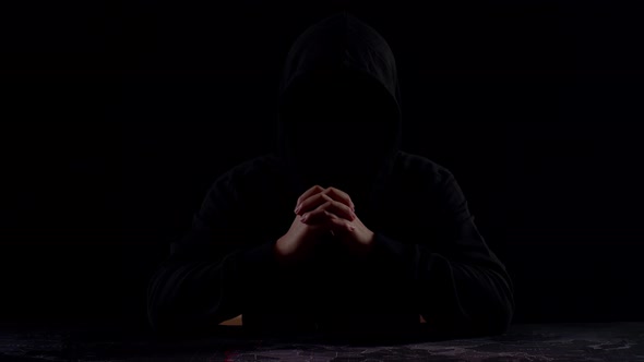 Mysterious Man With Hoodie In Silhouette Isolated On Black Background