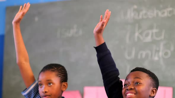 Schoolkids hand raised in the classroom 4k