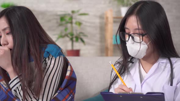 Doctor Protective Medical Mask Interviews Sick Asian Woman Close Up