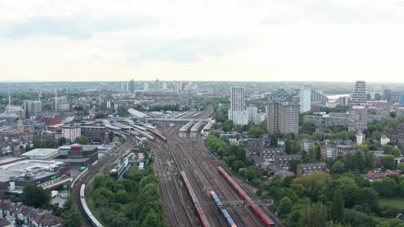 slow dolly forward drone shot of busy London Clapham Junction train station