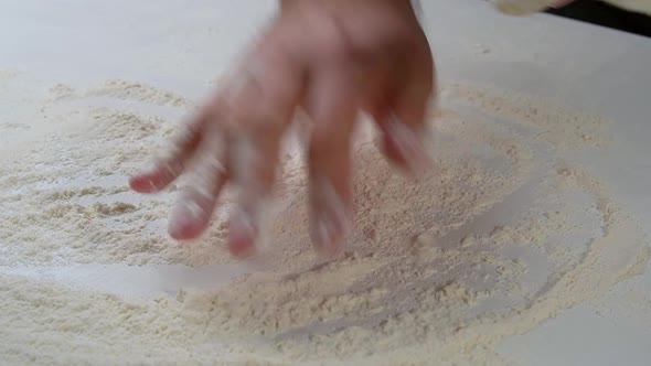 Professional Chef Stretches and Twists Soft Italian Pizza Dough with His Hands