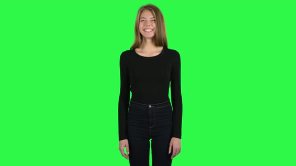 Young Woman Smiling While Looking at Camera and Laughing. Green Screen