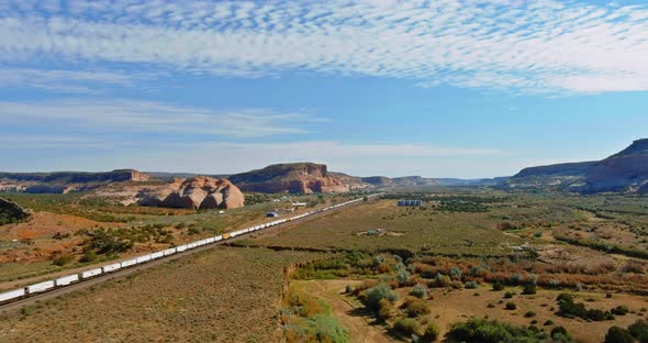 Aerial Views Over Train Going Through Dry Lands in a Desert New Mexico USA